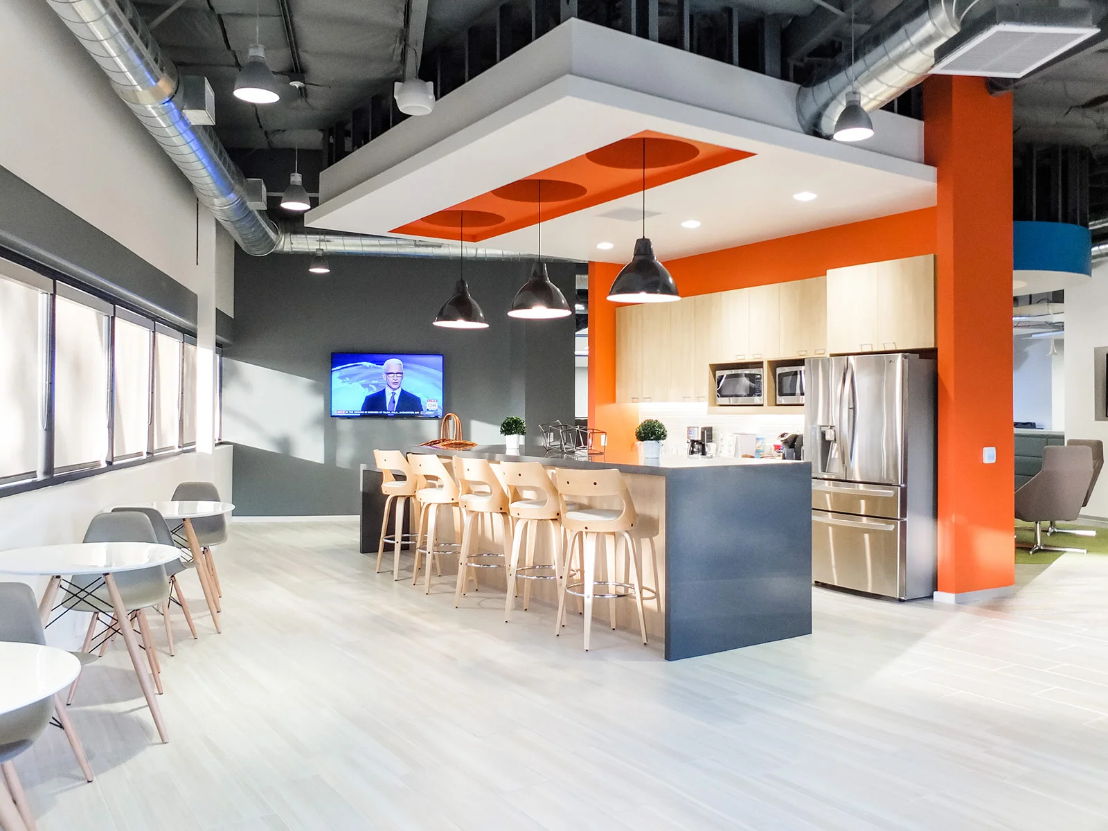 A sleek, modern kitchen area designed by KARDENT tenant improvement architects.